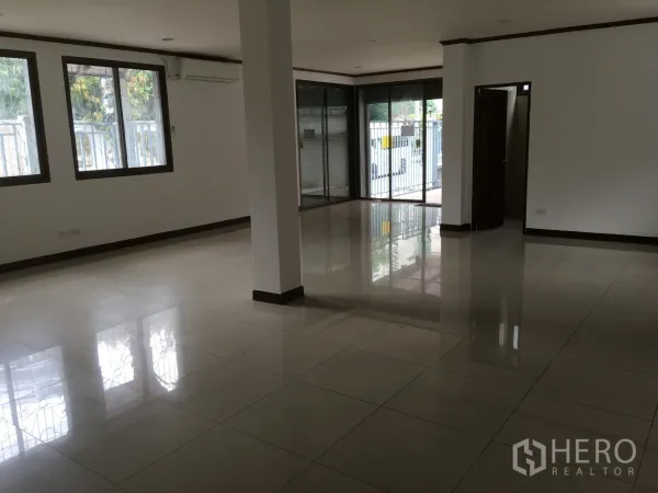 联排别墅 出租在Khlong Toei, Bangkok - 一层空间，落地窗与推拉玻璃门，临街安全栅栏