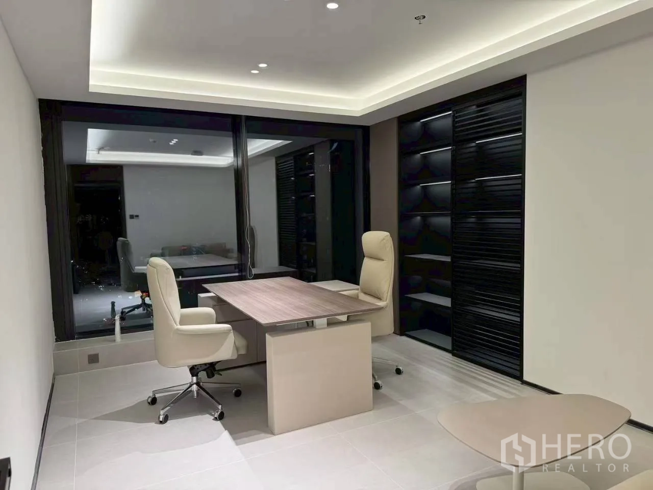 Office Space for rent in Din Daeng, Bangkok - Executive office with a desk, two swivel chairs, glass partition, and built-in shelving.