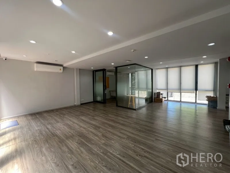 Home Office for rent or sale in Phra Khanong, Bangkok - Spacious office area with glass meeting room and roller blinds.