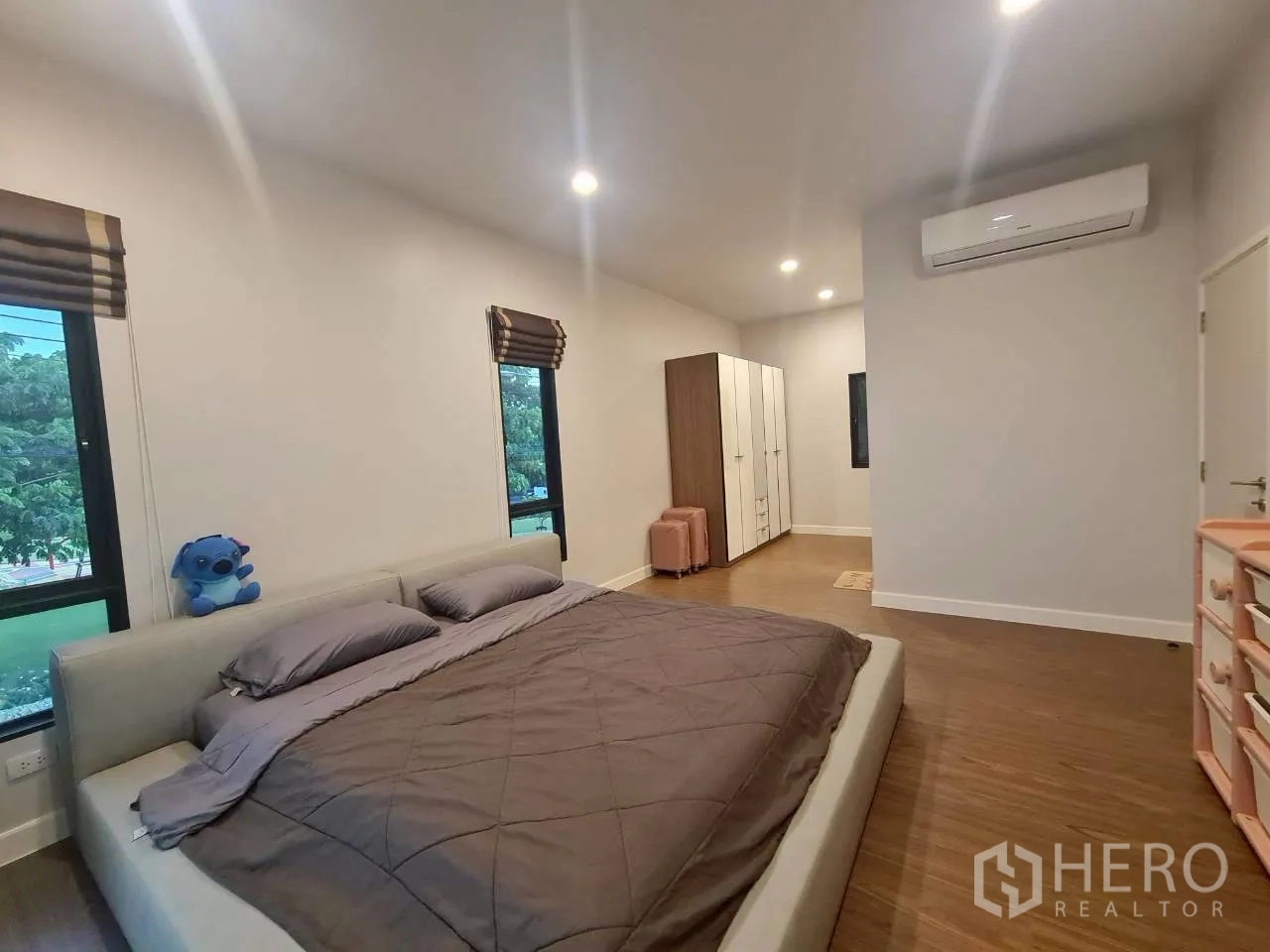 Detached House for rent or sale in Lam Luk Ka, Pathum Thani - Master bedroom view showing wardrobes and split-type air conditioning.