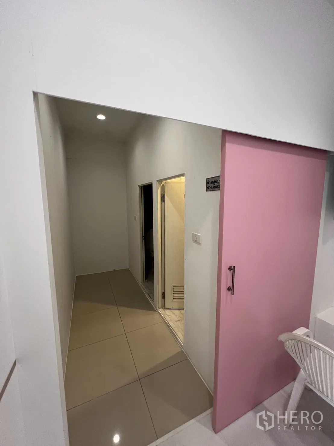 Retail Space for rent in Watthana, Bangkok - Hallway with pink sliding door leading to storage and utility rooms.