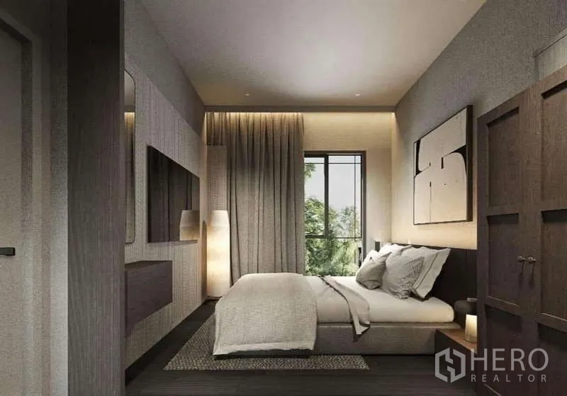 Townhouse for rent in Suan Luang, Bangkok - Warm-toned bedroom with wardrobe, feature lighting, and window views of trees.