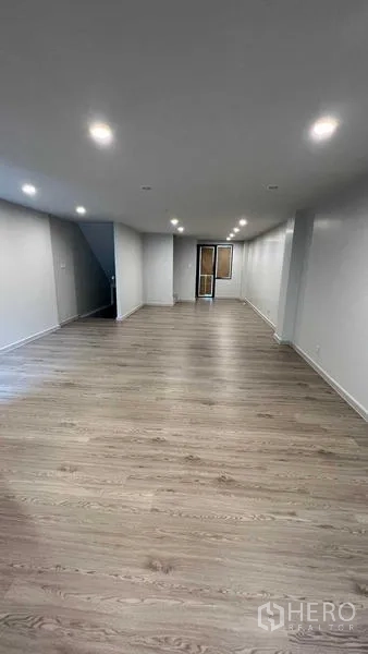 Home Office for rent - Spacious open-plan office floor with wood laminate flooring and recessed ceiling lights.