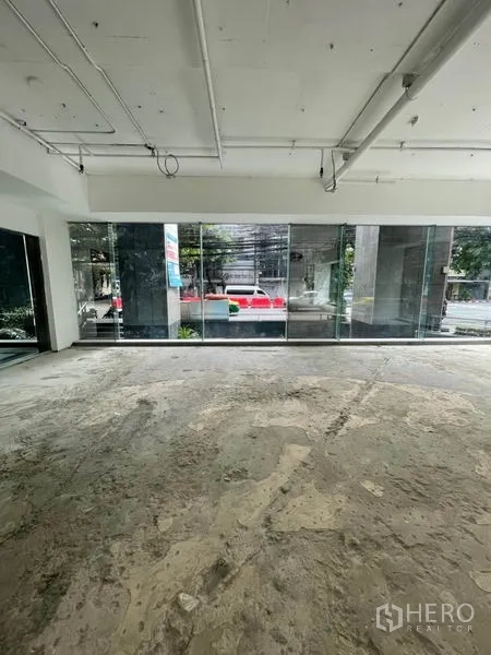 Retail Space for rent in Watthana, Bangkok - Retail space with floor-to-ceiling windows overlooking the street and landscaped greenery.