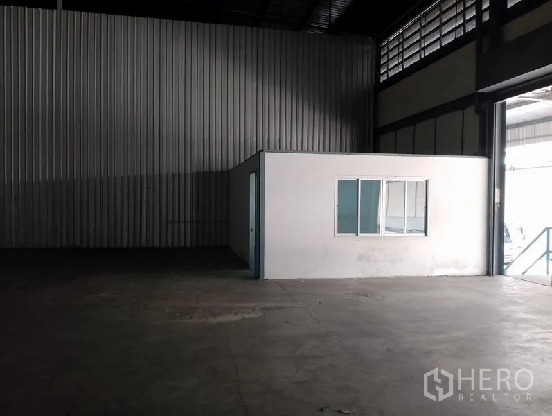 Warehouse for rent in Bang Phli, Samut Prakan - Small internal office room inside the warehouse near a loading door.