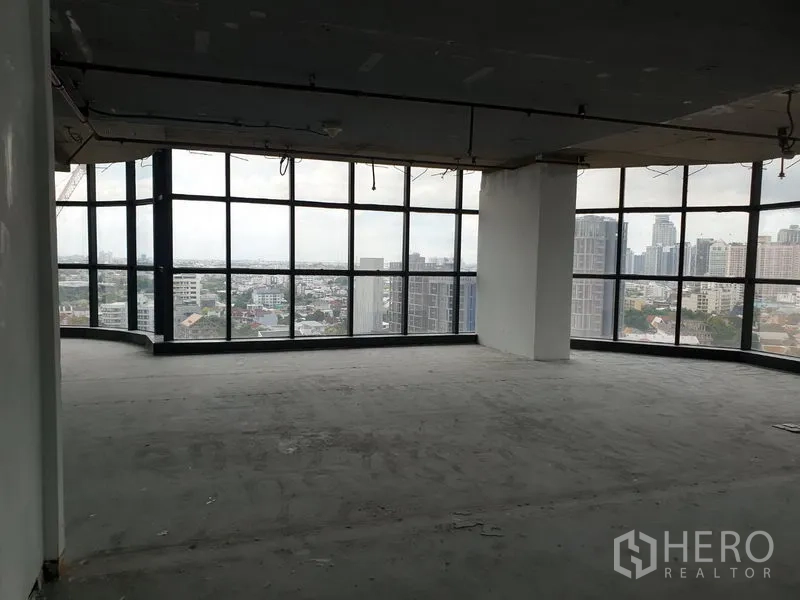 Office Space for rent in Watthana, Bangkok - Corner office shell with floor-to-ceiling windows and panoramic Bangkok skyline views.