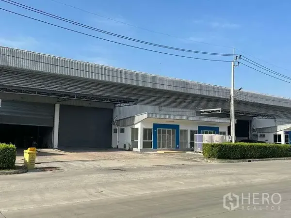 Factory for rent in Bang Sao Thong, Samut Prakan - Factory front elevation showing oversized roller door and office entrance.