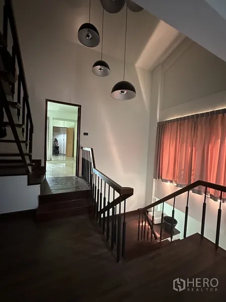 Home Office for rent in Watthana, Bangkok - Staircase landing with pendant lights and wood handrail.