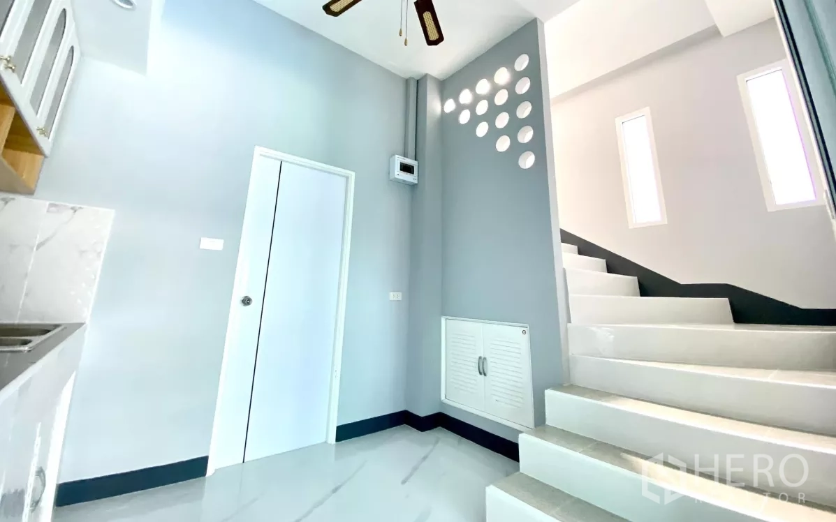 Factory for rent or sale in Bang Bua Thong, Nonthaburi - Kitchen and stair hall with modern ventilation details and storage panel.