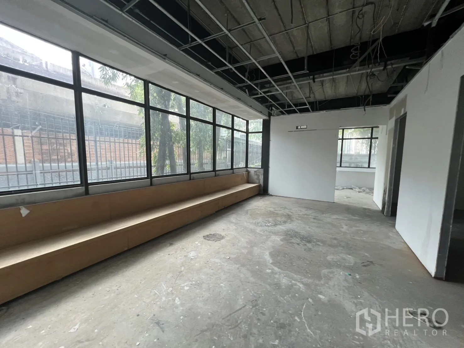 Retail Space for rent in Watthana, Bangkok - Interior room with a long built-in bench beneath full-length windows.