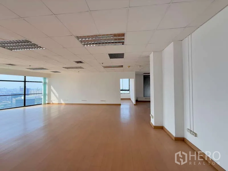 Office Space for rent in Chatuchak, Bangkok - Spacious bright workspace with large glazing and city views along one wall.
