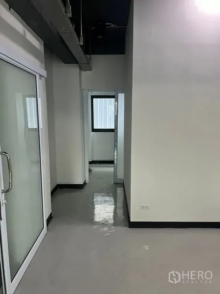 Retail Space for rent in Watthana, Bangkok - Hallway with sliding glass entry and small office rooms with a window.