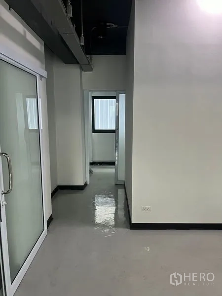 Retail Space for rent in Watthana, Bangkok - Hallway with sliding glass entry and small office rooms with a window.