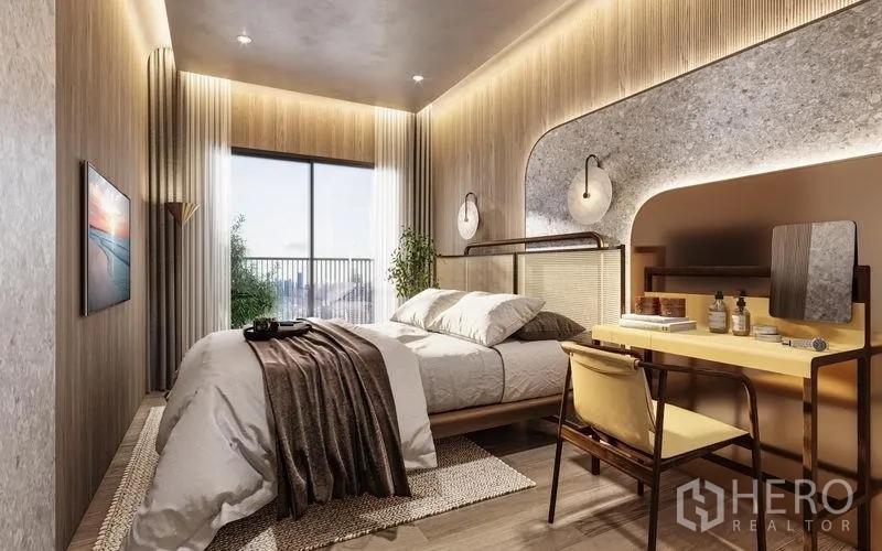 Condominium for sale in Khlong Toei, Bangkok - Cozy 1‑bedroom suite with warm lighting, built‑in desk and a balcony city view.