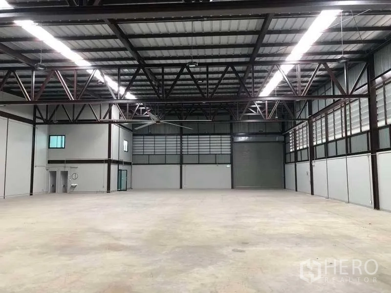 Warehouse for rent in Bang Phli, Samut Prakan - Wide interior space facing roller shutter door with ventilated louver panels.