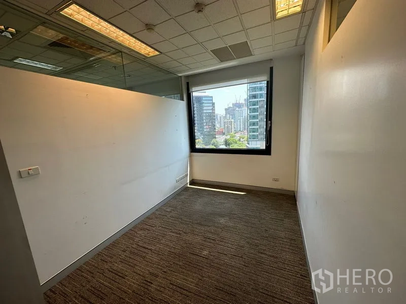 Office Space for rent - Private office with carpet, large window and urban skyline outlook.