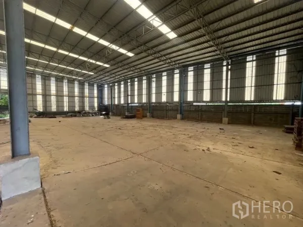 Warehouse for rent or sale in Bang Bon, Bangkok - Spacious warehouse interior featuring a high steel roof and skylights for natural light.