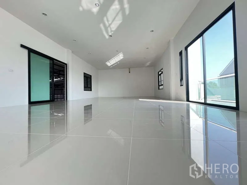 Warehouse for rent or sale - Bright tiled office level with sliding glass doors opening to a balcony.