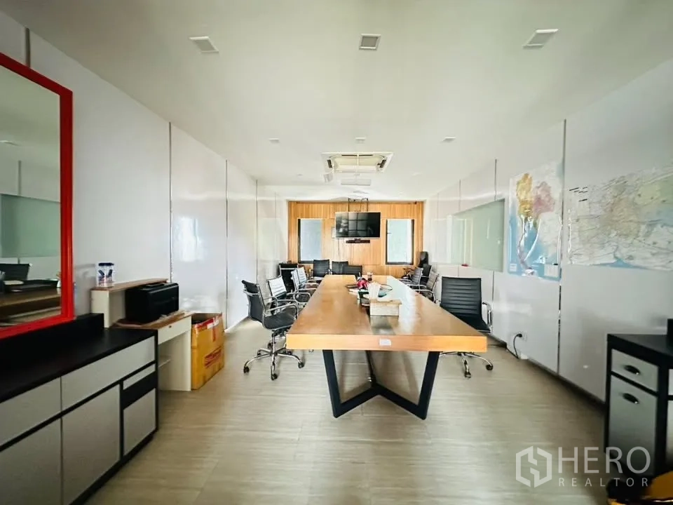 Shophouse for sale in Watthana, Bangkok - Spacious meeting room with long conference table, office chairs, and ceiling cassette air-con.