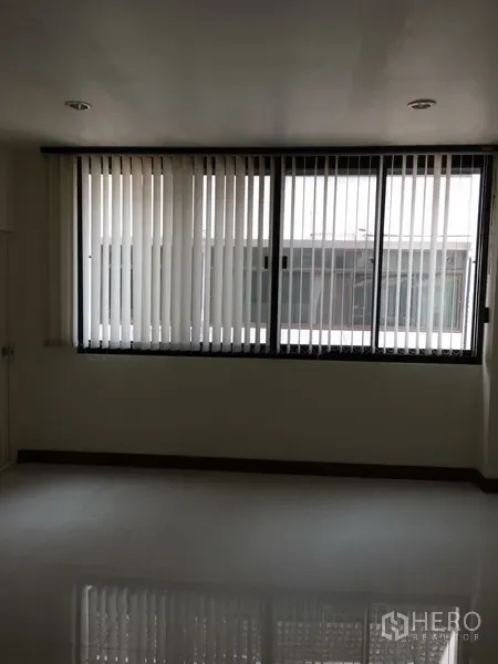 Home Office for rent in Bang Rak, Bangkok - Spacious office room with a wide window and vertical blinds bringing in daylight.