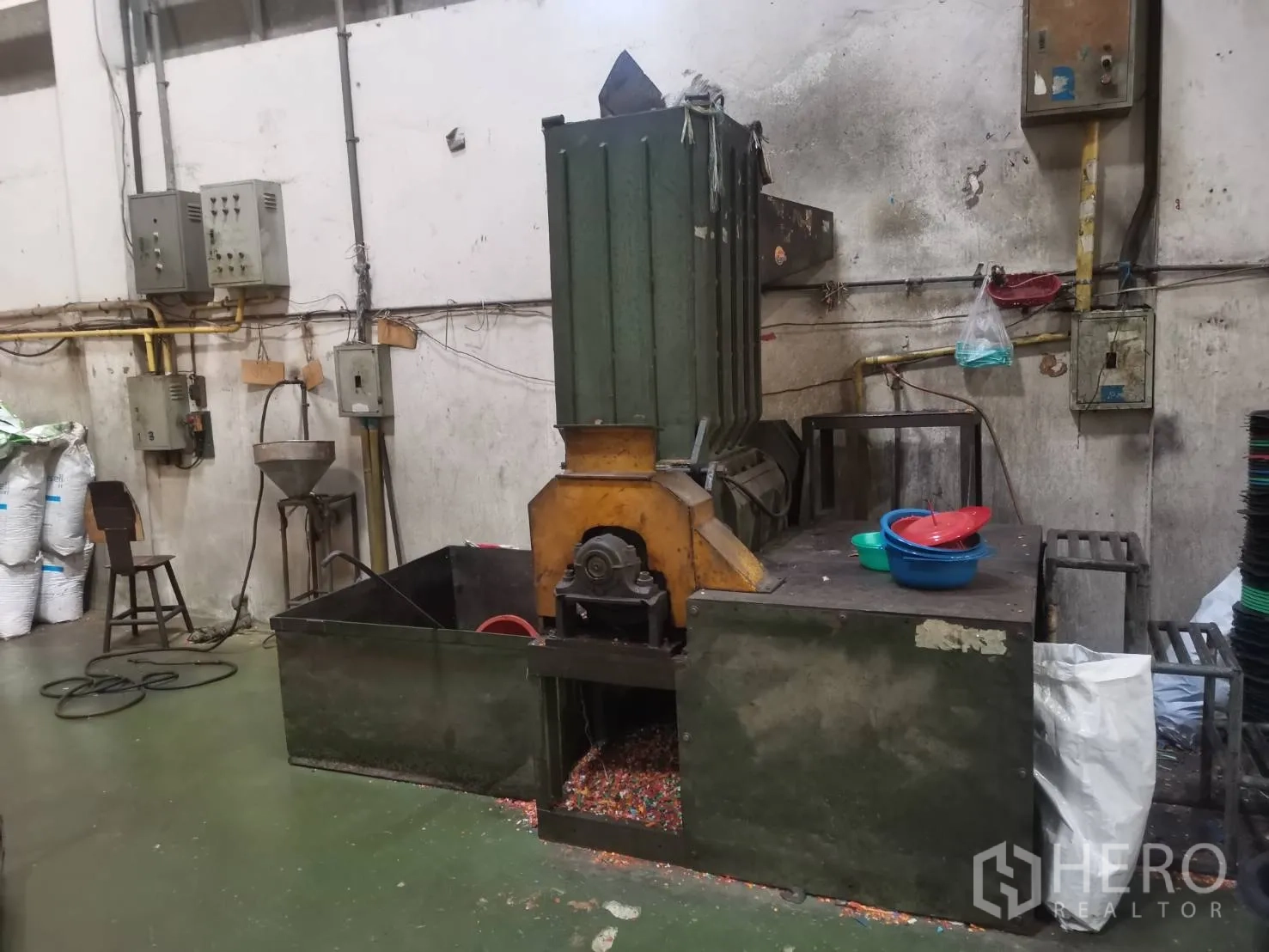 Factory for rent or sale in Bang Khun Thian, Bangkok - Plastic shredder and granulator machine with hopper and work platform.