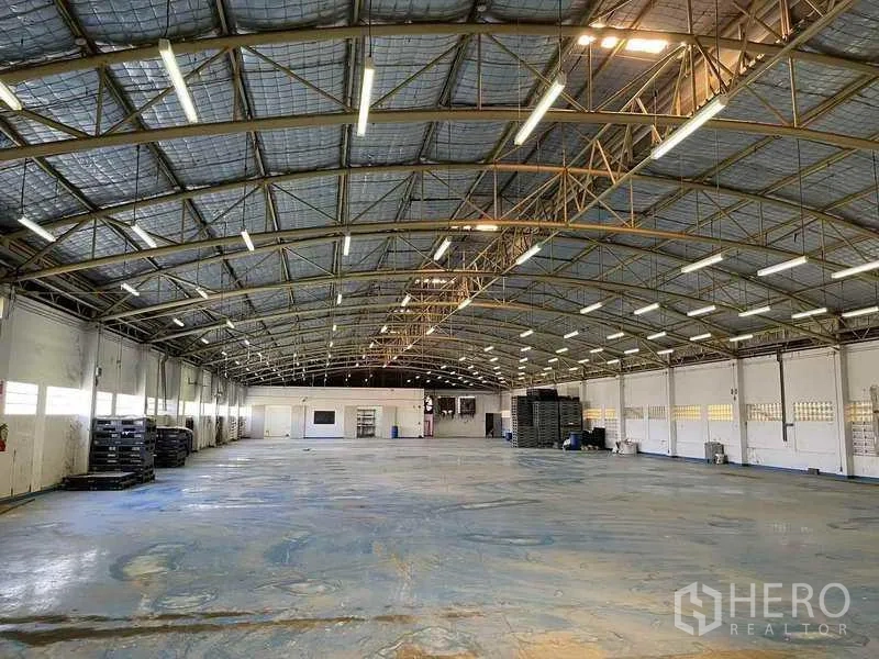 Factory for rent in Phra Samut Chedi, Samut Prakan - Expansive insulated arched‑roof warehouse hall with bright lighting.