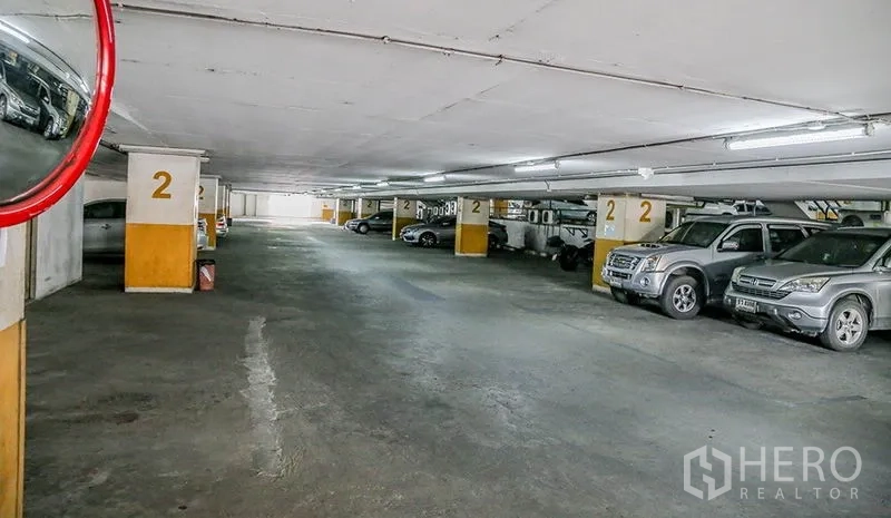 Office Space for rent in Bang Na, Bangkok - Underground parking garage with marked bays and multiple parked cars.