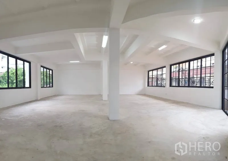Home Office for rent or sale in Bang Na, Bangkok - Upper floor open workspace with windows on two sides.