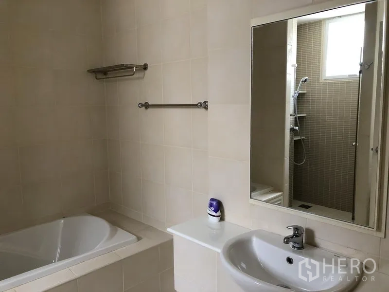Detached House for rent in Watthana, Bangkok - Bathroom featuring a bathtub, sink with mirror, and a separate glass shower.