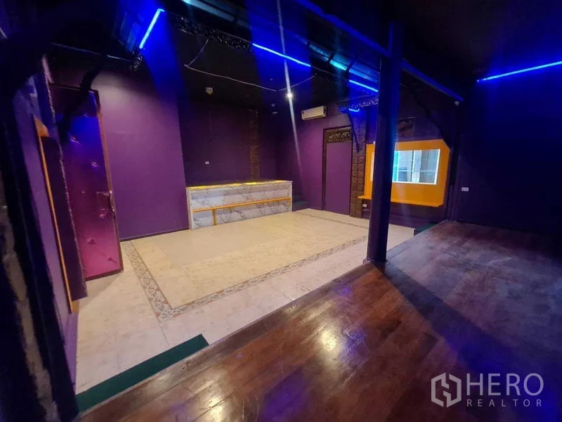 Retail Space for rent in Watthana, Bangkok - Open space with stage flooring, service counter and a yellow framed display window.