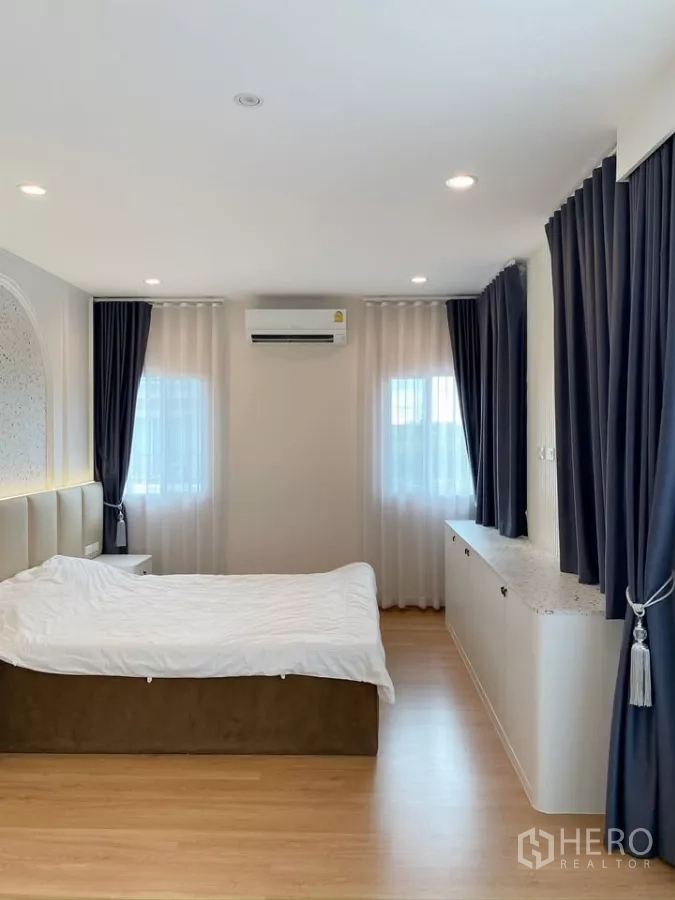 Detached House for sale in Sai Mai, Bangkok - Spacious master bedroom with large windows, sheer and blackout curtains.
