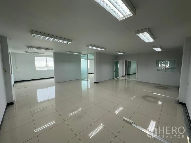 Warehouse for rent in Phra Nakhon Si Ayutthaya - Open-plan office space with glass partitions and modern ceiling lights.