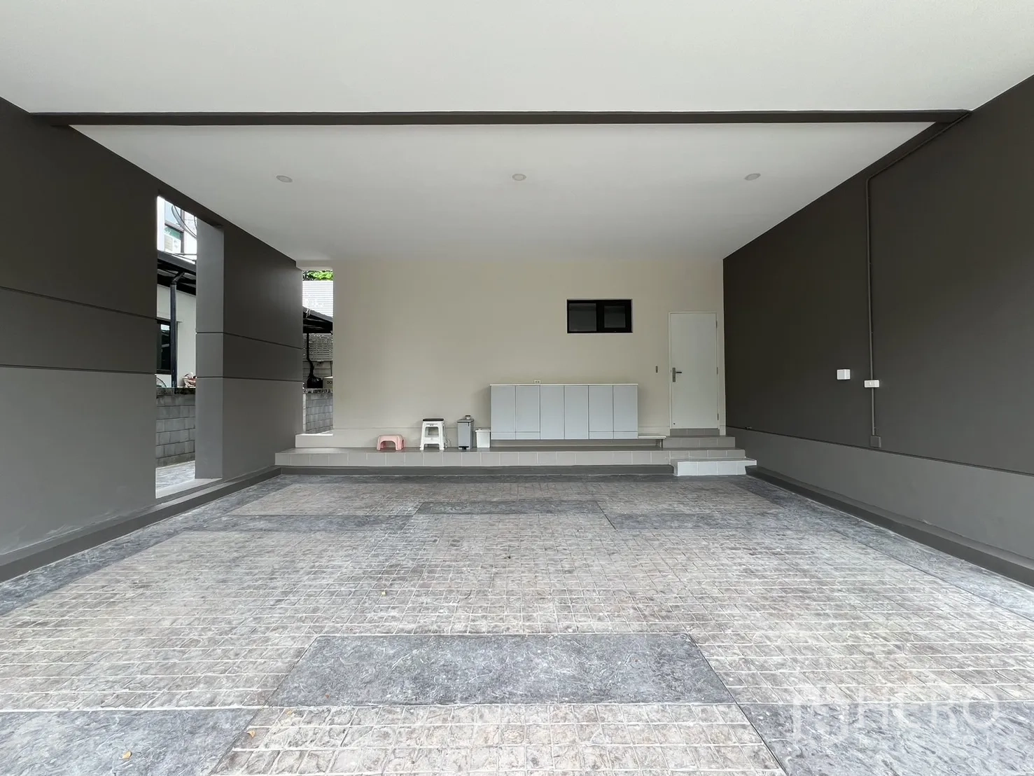 Detached House for rent or sale in Prawet, Bangkok - Covered three-car carport with tiled floor and storage cabinet.