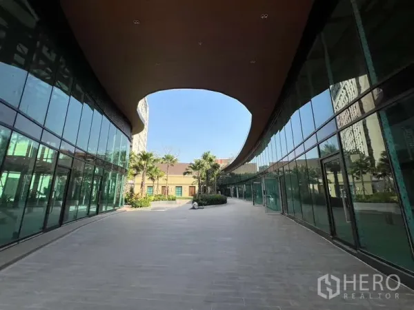 Retail Space for rent in Watthana, Bangkok - Open pedestrian walkway between twin glass retail blocks under a wooden canopy.