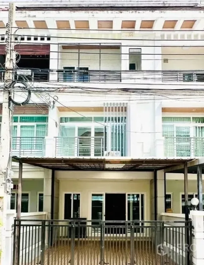 Townhouse for rent in Prawet, Bangkok - Front exterior of a three-level townhouse with balcony and gated terrace