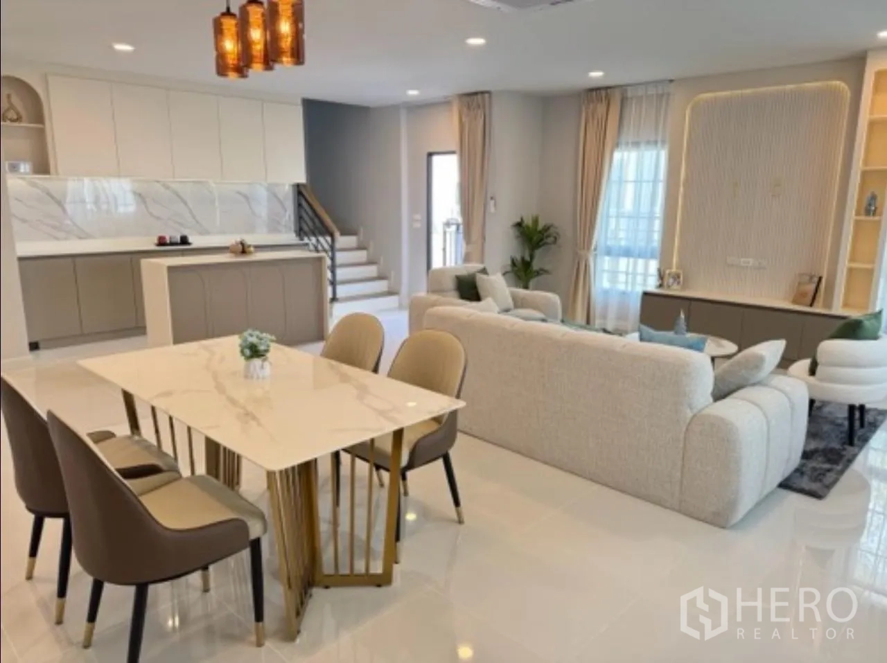 Detached House for rent in Bang Phli, Samut Prakan - Dining area beside the living room with marble table and staircase beyond.
