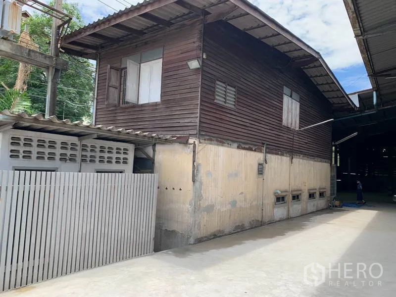货栈 出租在Yan Nawa, Bangkok - 仓库旁的木质办公楼与混凝土通道及金属栅栏