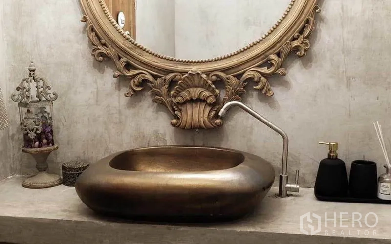 Townhouse for rent in Watthana, Bangkok - Close-up of an ornate vanity with bronze basin and decorative framed mirror.