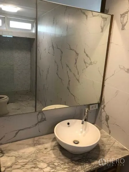 Detached House for rent in Watthana, Bangkok - Modern bathroom with marble-effect walls and round basin.