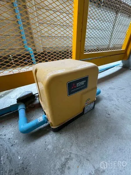 Warehouse for rent in Bang Phli, Samut Prakan - Close-up of a water pump connected to blue piping in the service area