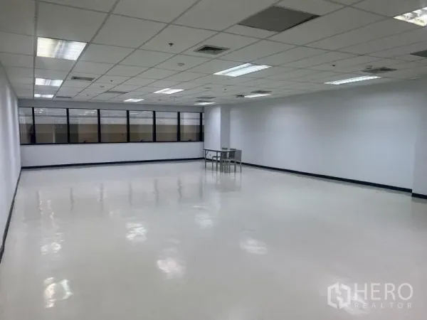 Office Space for rent in Watthana, Bangkok - Wide view of large office area featuring window wall and a small meeting table.