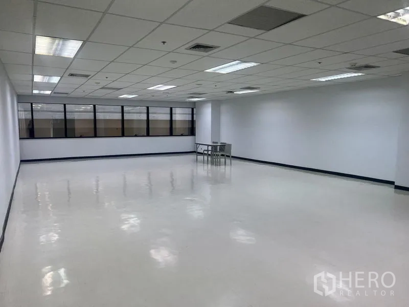 Office Space for rent in Watthana, Bangkok - Wide view of large office area featuring window wall and a small meeting table.