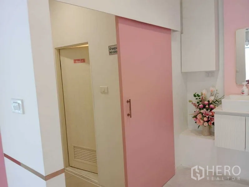 Retail Space for rent in Watthana, Bangkok - Powder area with pink sliding door, vanity sink and floral decor.