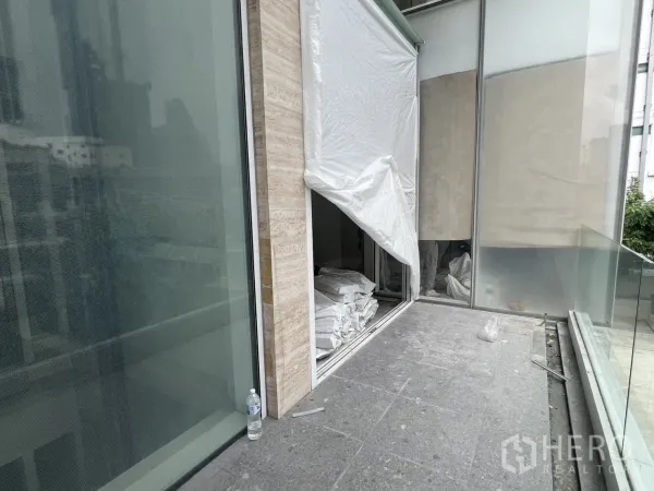 Retail Space for rent - Private outdoor terrace with glass railing outside the retail unit.