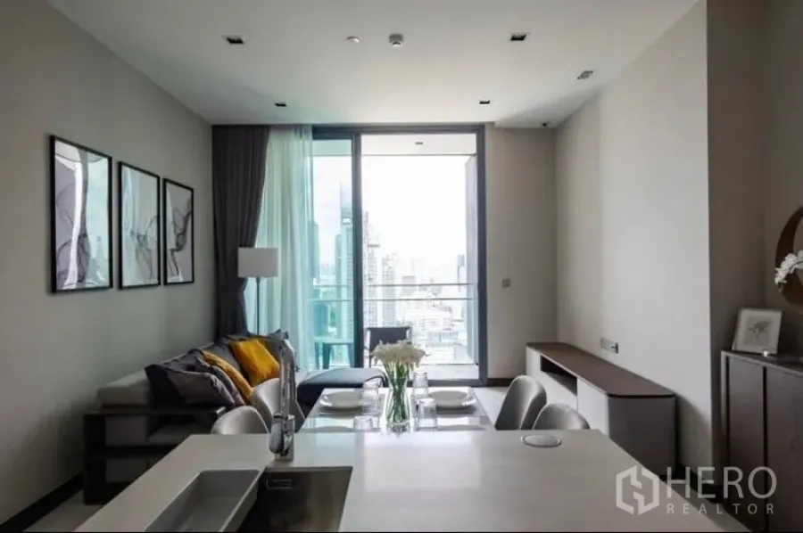 Condominium for rent - Living room leading to balcony overlooking the city skyline.