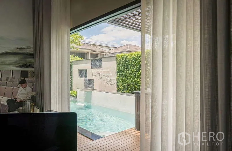 Detached House for rent or sale in Bang Kapi, Bangkok - View from the lounge to a private lap pool and deck through sliding glass.