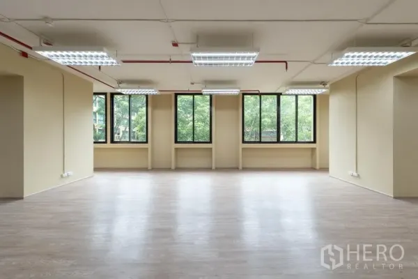 Office Space for rent in Chatuchak, Bangkok - Bright workspace with rows of tall windows, neutral walls, and tree views at a Chatuchak office for lease.