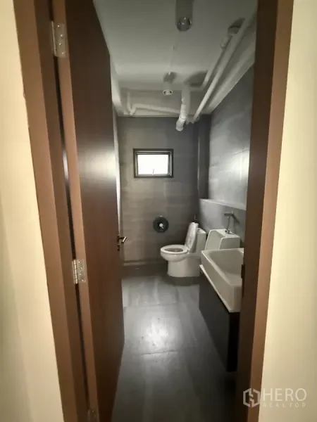 Office Space for rent in Bang Rak, Bangkok - Modern restroom with toilet, urinal and sink inside the office unit.