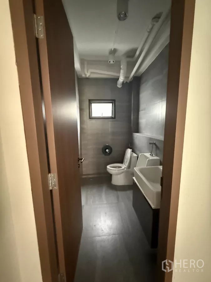 Office Space for rent in Bang Rak, Bangkok - Modern restroom with toilet, urinal and sink inside the office unit.