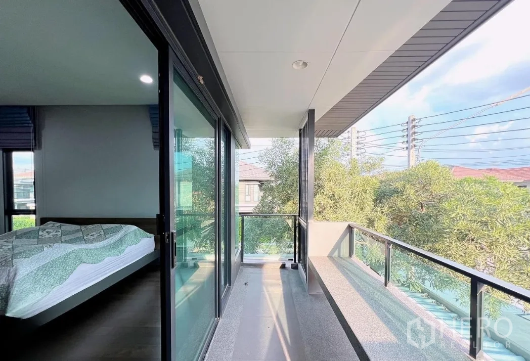 Detached House for rent or sale in Lam Luk Ka, Pathum Thani - Private balcony off the master bedroom with glass railing.